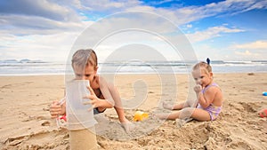 Kids Small Girl Boy Gambol Make Sand Cake on Beach