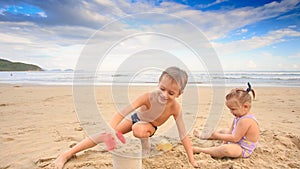 Kids Small Girl Boy Gambol Play with Wet Sand on Beach