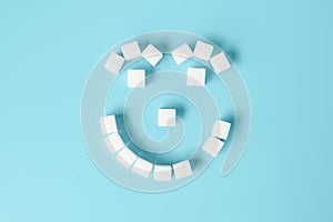 Kids smiling face with tooth decay made of sugar cubes on blue b