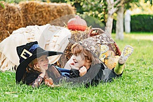 Kids smiling on a Halloween party. Happy Halloween Cute children daughter and son making funny faces with a pumpkin