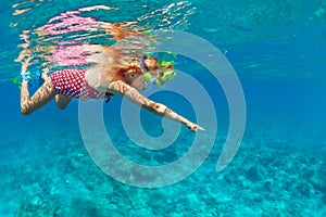 Kids in snorkeling mask dive underwater in blue sea lagoon