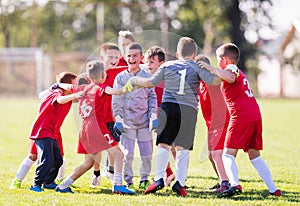 Kids soccer football - children players celebrating after victo