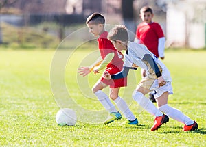 Kids soccer football - children players match on soccer field