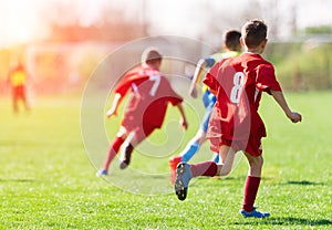 Kids soccer football - children players match on soccer field