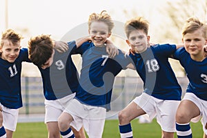 Kids soccer players celebrate a winning in school sports tournament