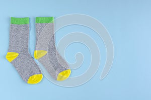 Kids socks composition on blue background. Flat lay