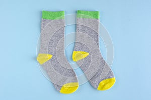 Kids socks composition on blue background. Flat lay