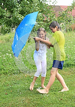 Kids splashed with garden hose photo