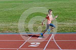 Kids sport, child running on stadium track, training and fitness