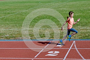 Kids sport, child running on stadium track, training and fitness