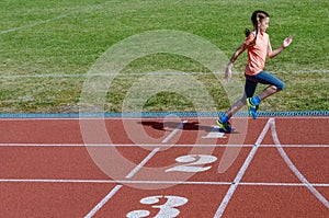 Kids sport, child running on stadium track, training and fitness