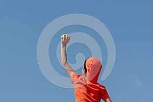 Kids sport tennis game concept. Boy child tennis player holding ball on blue sky. Children`s sports activity. copy space