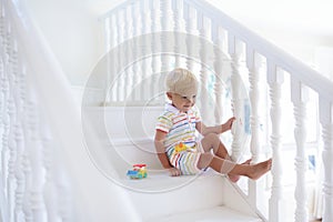 Kids on stairs. Child moving into new home.