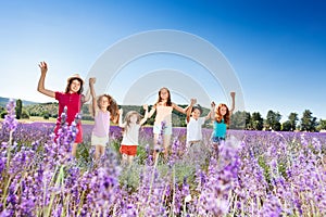 Kids standing in lavender field and holding hands