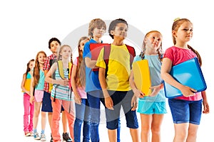 Kids standing in the line holding textbooks