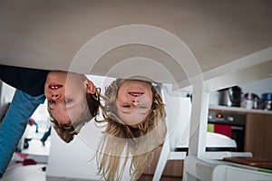 Kids staying home, boy and girl play hide and seek indoors