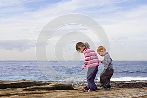 Kids stepping in rockpools