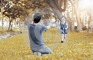 Kids student in uniform running into father`s hands