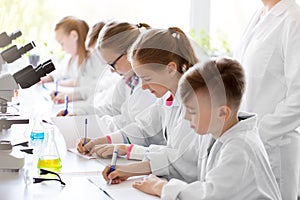 Kids studying chemistry at school laboratory