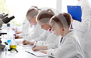 Kids studying chemistry at school laboratory