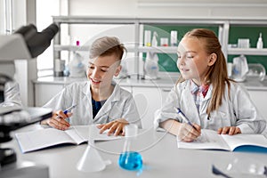 Kids studying chemistry at school laboratory