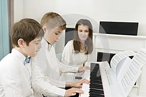 Kids Studying and Playing Piano in Tandem