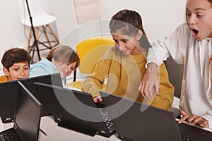 Kids studying together at computer school