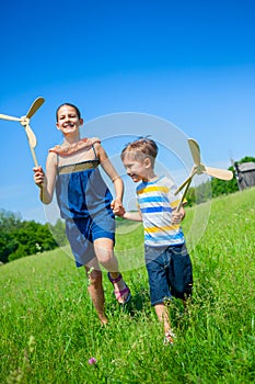 Kids in summer day holds windmill