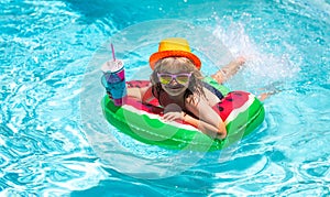 Kids summer vacation, swimming and relax. Cute funny child boy relaxing with toy swimming ring in a swim pool having fun