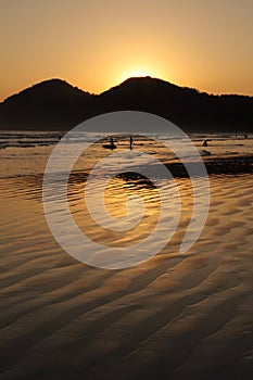 Kids and Sunset Reflexion at a tropical beach