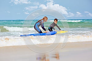 Kids with surfboards near sea