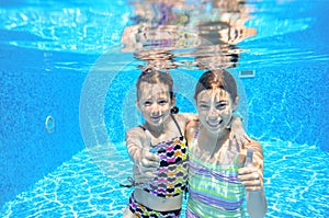 Kids swim in pool underwater