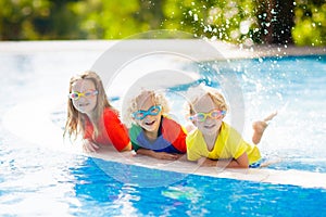 Kids in swimming pool. Children swim. Family fun