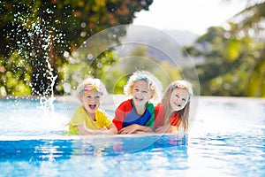 Kids in swimming pool. Children swim. Family fun