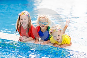 Kids in swimming pool. Children swim. Family fun