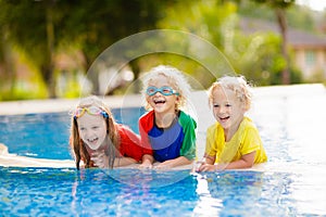 Kids in swimming pool. Children swim. Family fun