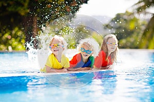 Kids in swimming pool. Children swim. Family fun