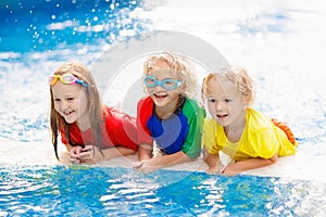 Kids in swimming pool. Children swim. Family fun photo