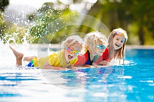 Kids in swimming pool. Children swim. Family fun photo