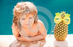 Kids Swimming Pool Concept. Summer vacation. Relax in spa swimming pool. Children playing in pool. Summer pineapple