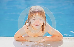 Kids in swimming pool, head of cute blond child. Kids summer activities.