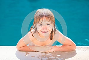 Kids in swimming pool, head of cute blond child. Kids summer activities.