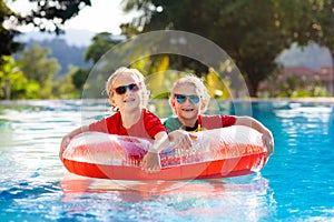 Kids in swimming pool. Life jacket for child