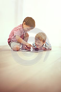 Kids, tablet and happy siblings on floor for funny cartoon, gaming or movie at home. Digital, learning and boy children