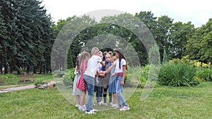 Kids team building. A group of happy children holding hands together. Team outdoor in park