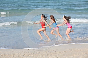 Kids, teens running on beach vacation