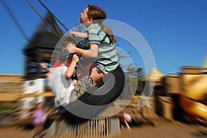 Kids on tire swing photo