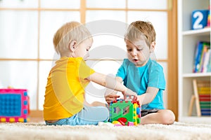 Kids toddler preschooler boys playing logical toy learning shapes and colors at home or nursery