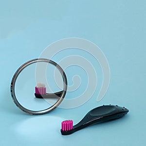 Kids toothbrush with toothpaste mirorr reflection. International day of dentist. Creative concept of daily morning