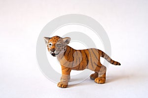 A kids toy tiger cub on a white background.